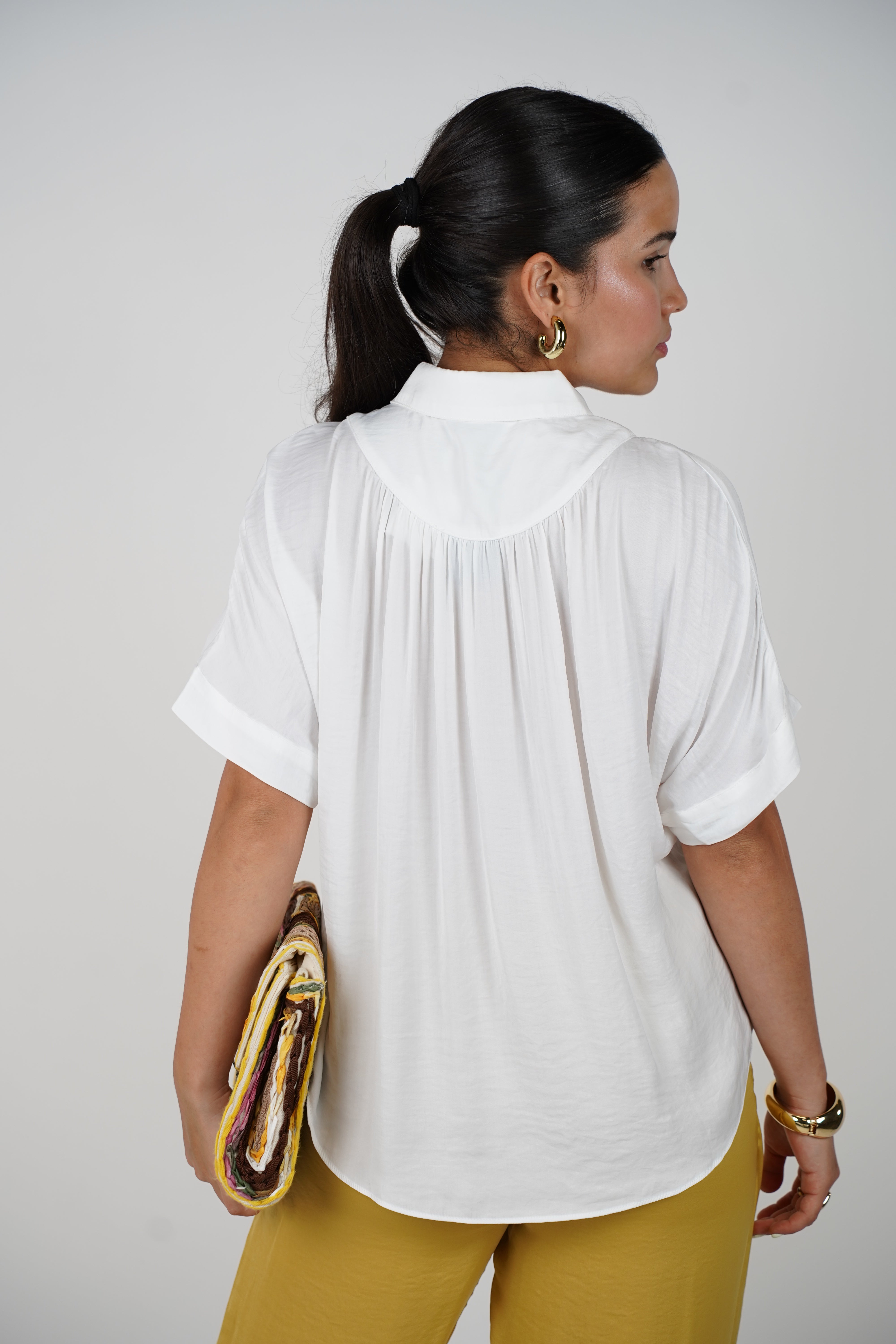 Jeyra Flaca Top – Draped Black Blouse with Modern Ease